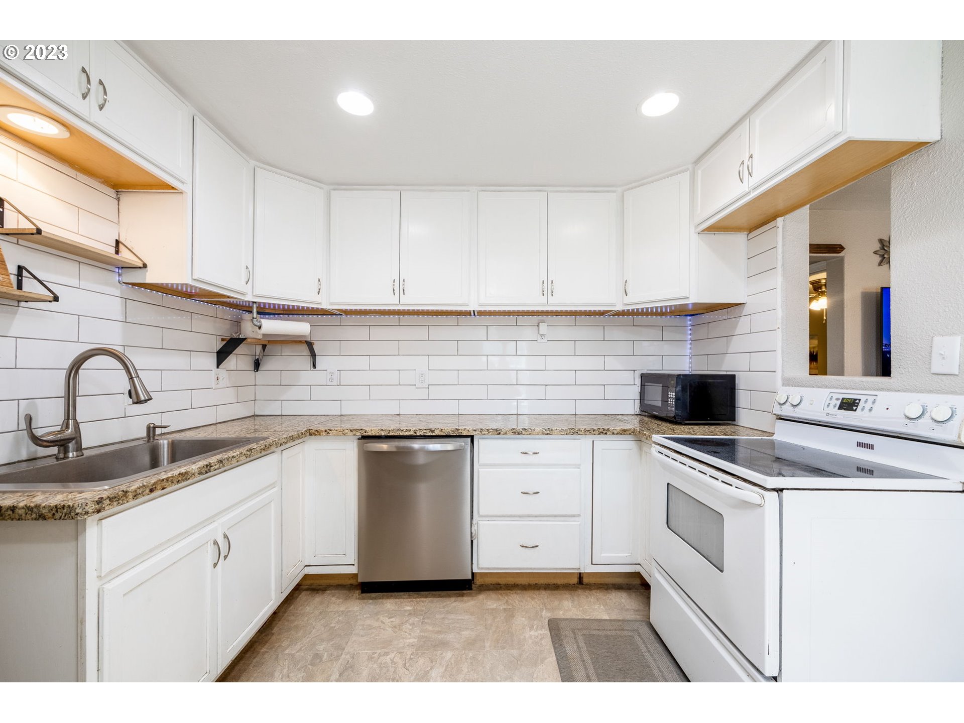 2065 G Street Springfield, OR 97477 - Photo 4 of 37 a kitchen with white cabinets appliances and a sink