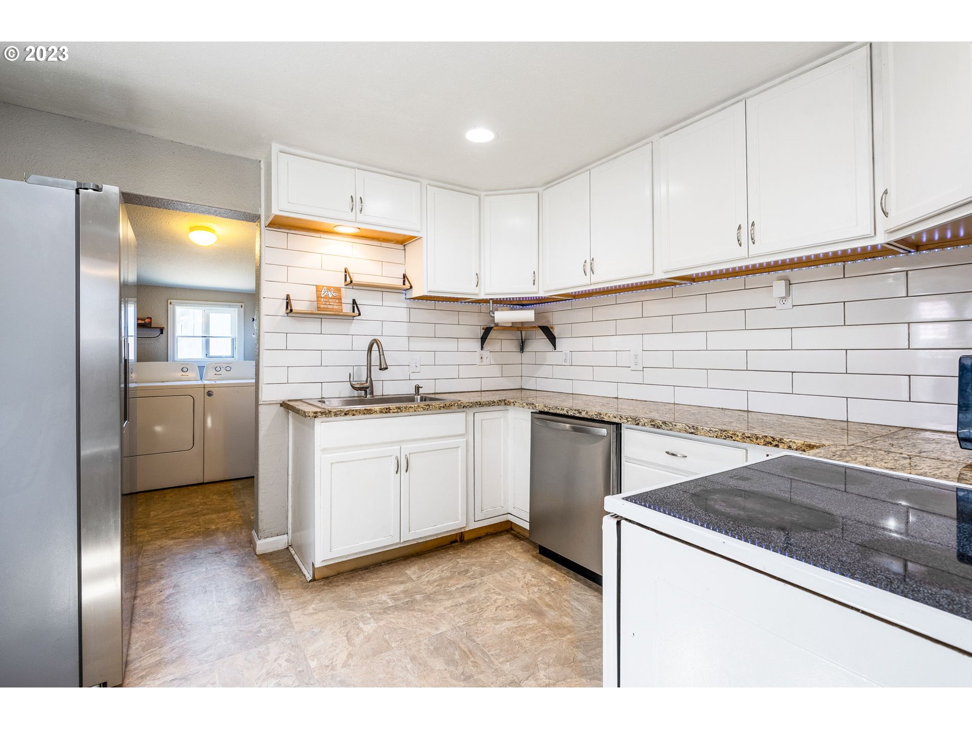 2065 G Street Springfield, OR 97477 - Photo 5 of 37 a kitchen with a sink stove and cabinets