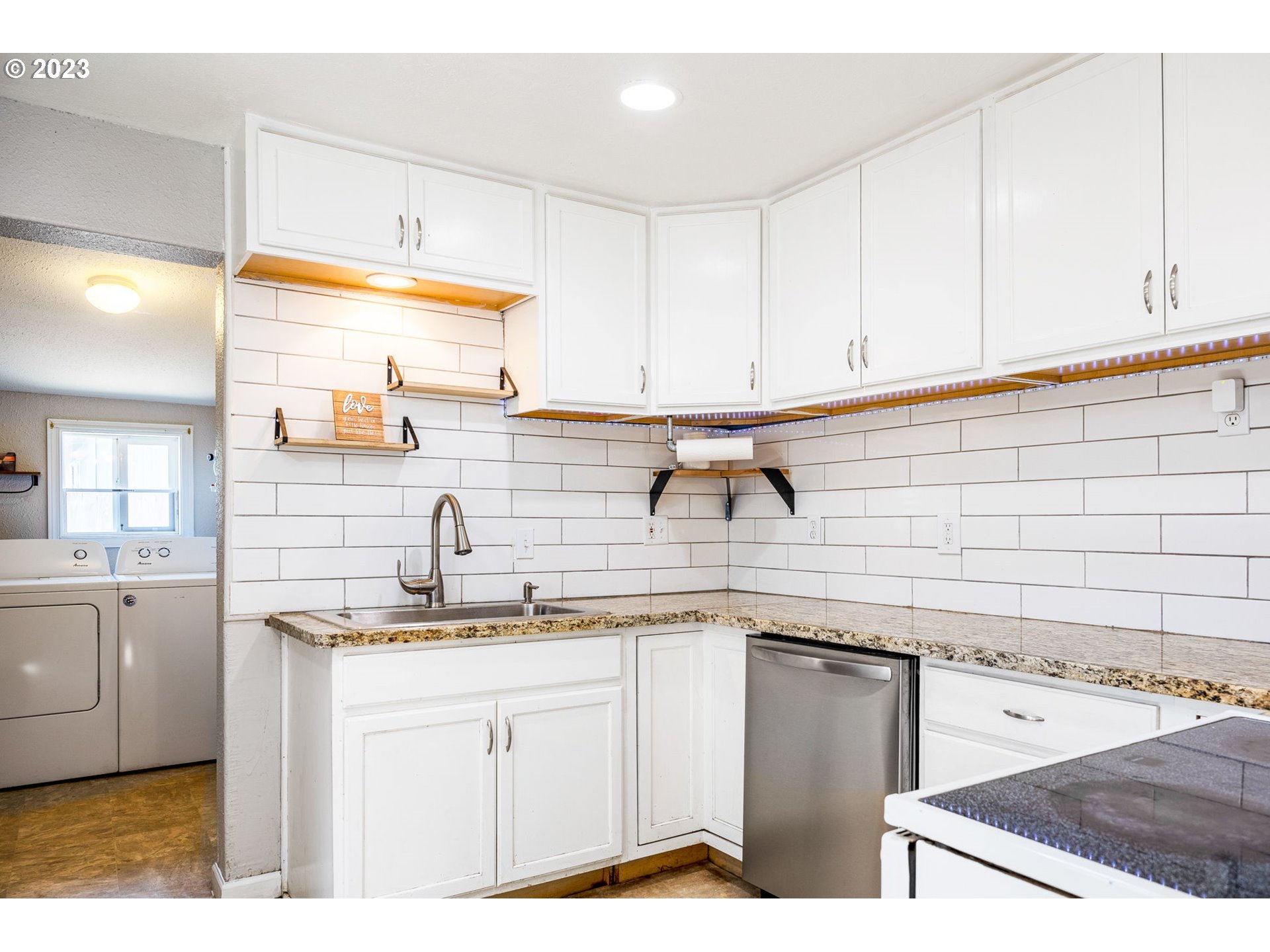 2065 G Street Springfield, OR 97477 - Photo 6 of 37 a kitchen with granite countertop a sink a stove and cabinets