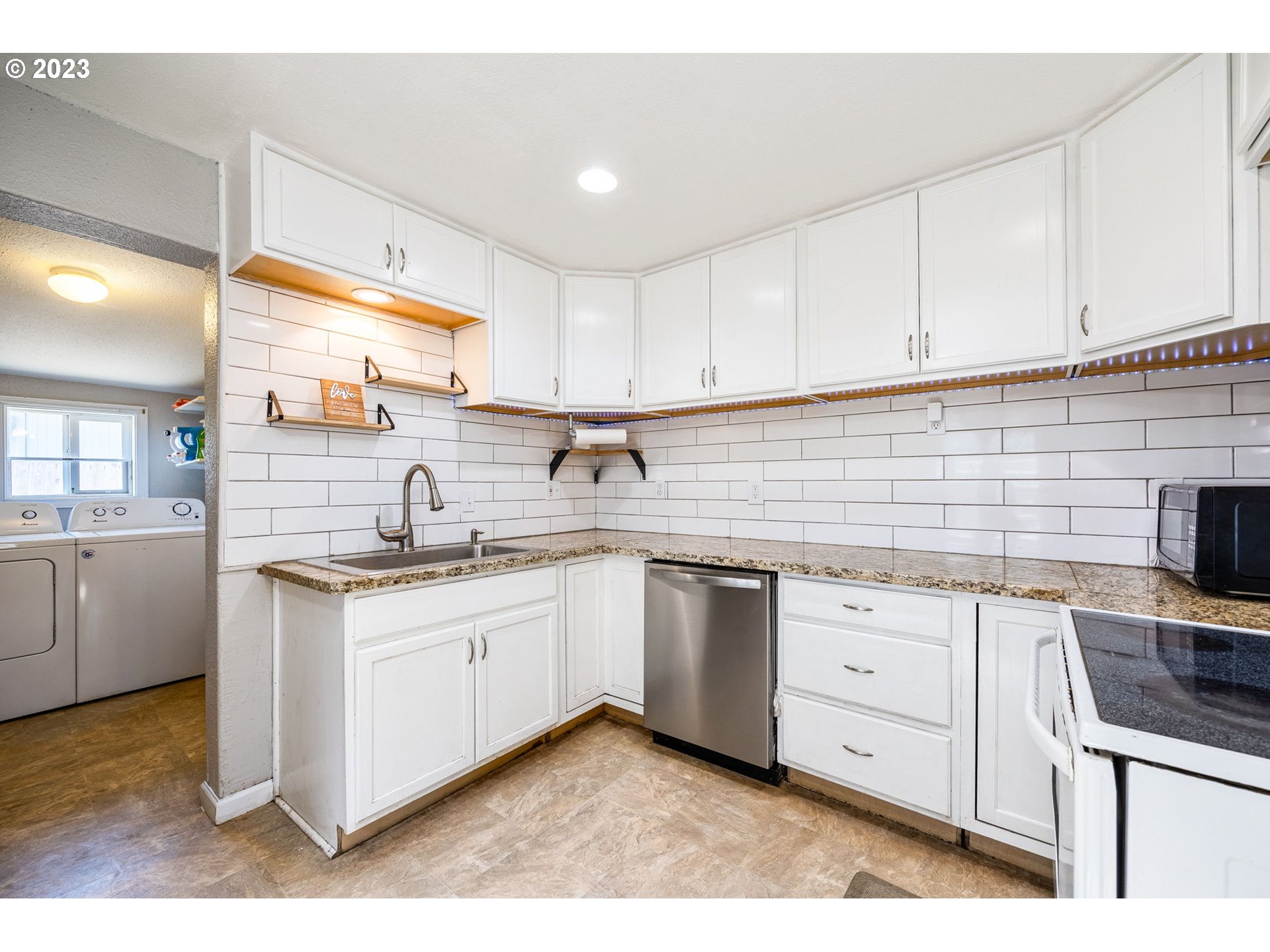 2065 G Street Springfield, OR 97477 - Photo 7 of 37 a kitchen with granite countertop a sink stainless steel appliances and cabinets