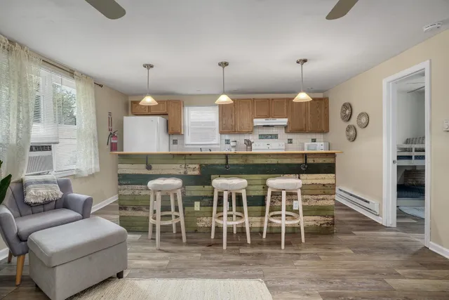 a large kitchen with a table and chairs