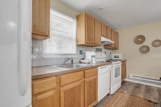 a kitchen with stainless steel appliances granite countertop a sink a stove and cabinets