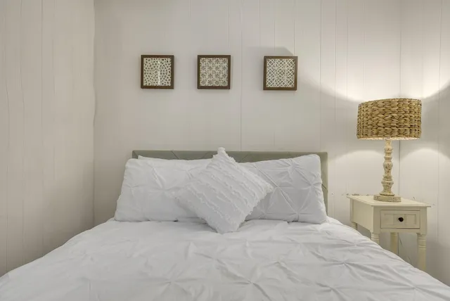 a bedroom with a bed and a lamp