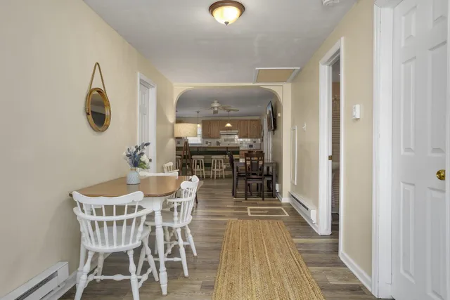a view of a dining room with furniture and wooden floor