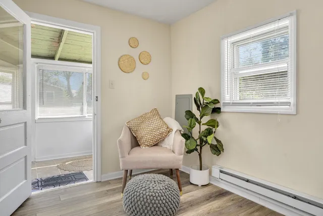 a white vase with white and yellow flowers