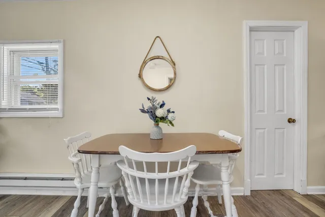 a view of a dining room with furniture wooden floor and a chandelier