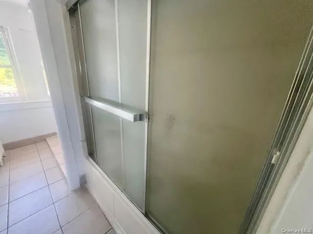 a bathroom with a toilet sink and window