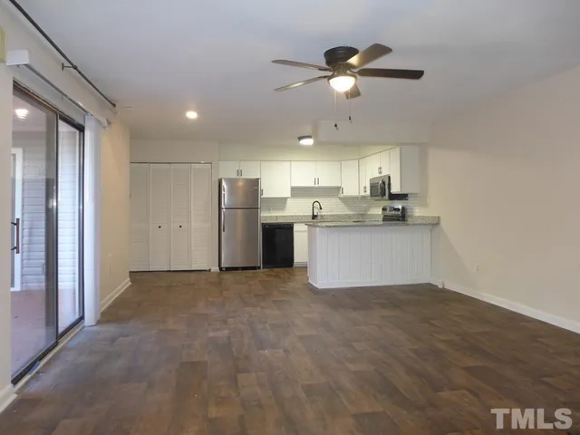 a view of a kitchen with a sink and cabinets