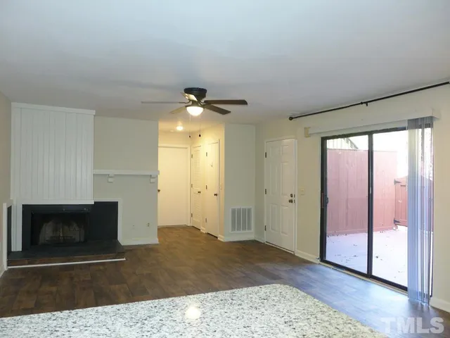 a view of an empty room and a fireplace