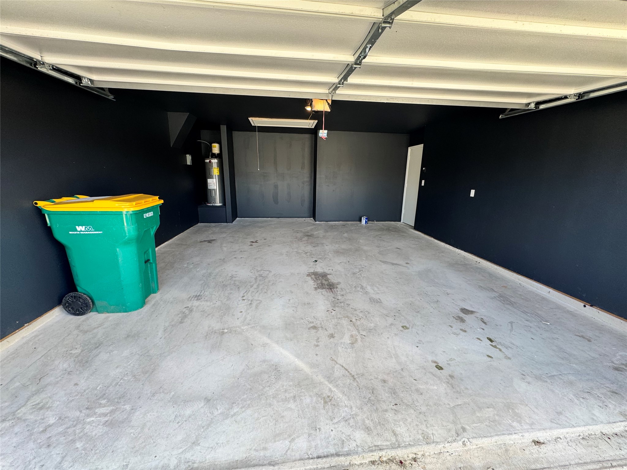 11820 Rush Lane Elgin, TX 78621 - Photo 30 of 31 A spacious garage featuring an overhead door and ample room for storage or vehicles.