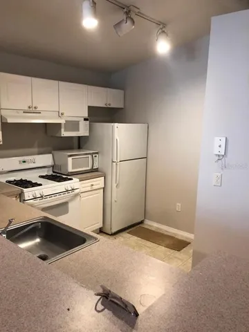 a kitchen with appliances and cabinets