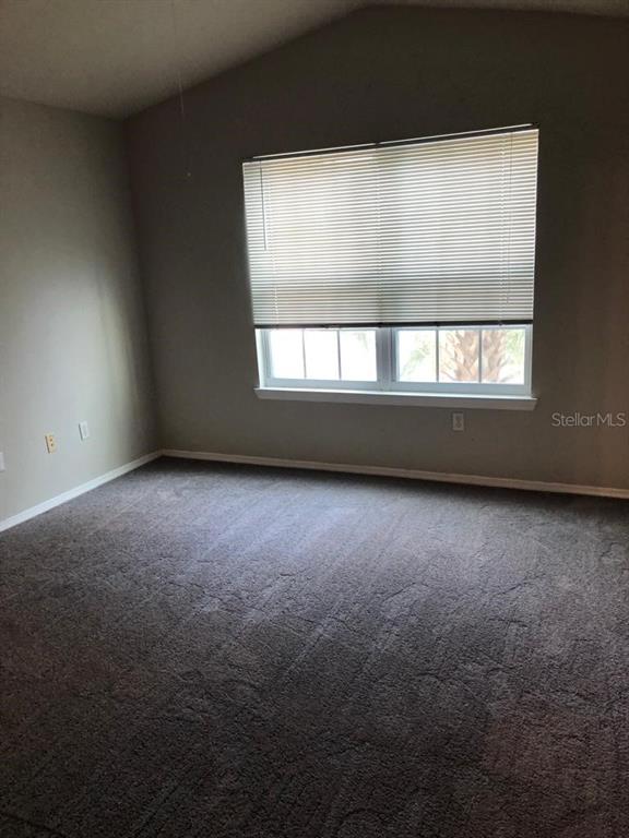 3397 South Kirkman Road, Unit 1435 Orlando, FL 32811 - Photo 4 of 11 an empty room with a window