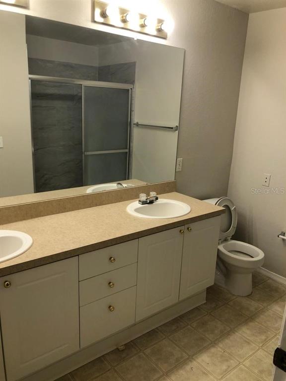 3397 South Kirkman Road, Unit 1435 Orlando, FL 32811 - Photo 7 of 11 a bathroom with a sink and a toilet