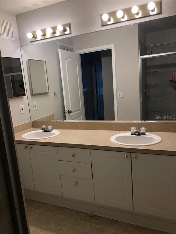 3397 South Kirkman Road, Unit 1435 Orlando, FL 32811 - Photo 8 of 11 a bathroom with a sink and a mirror