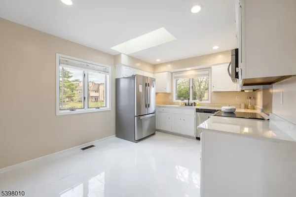 a kitchen with a refrigerator stove and sink