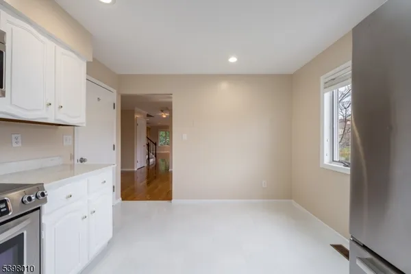 a bathroom with a granite countertop toilet sink and mirror