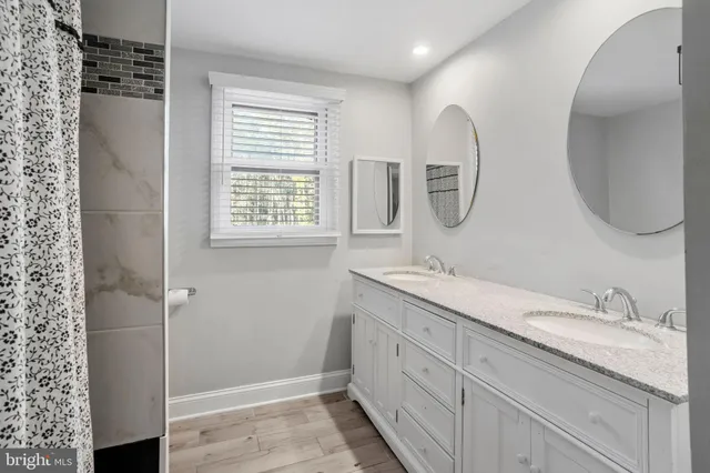 a spacious bathroom with a double vanity sink and a mirror