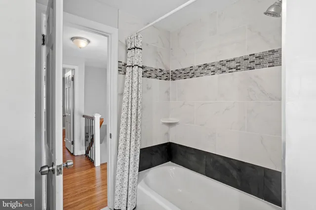 a bathroom with a bathtub a toilet and a shower