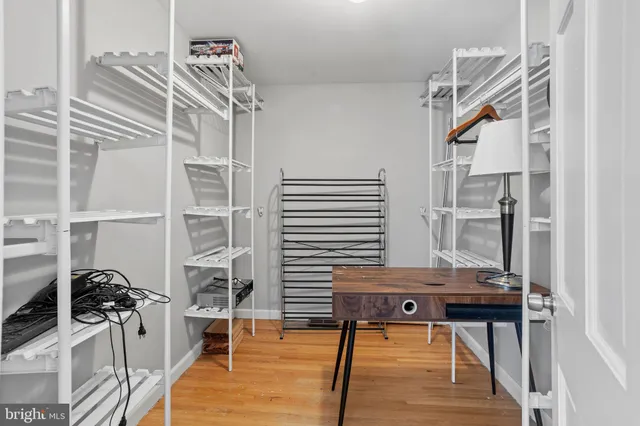 a view of a room with wooden floor and furniture