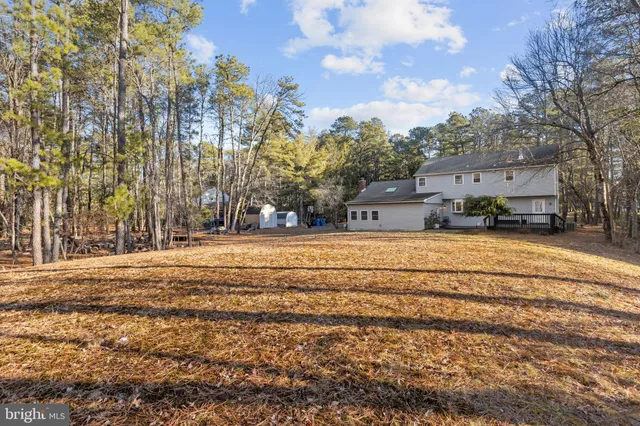 a swimming pool with outdoor seating and yard