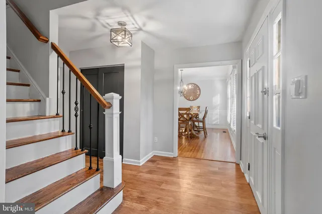 a view of a hallway view with wooden floor and staircase