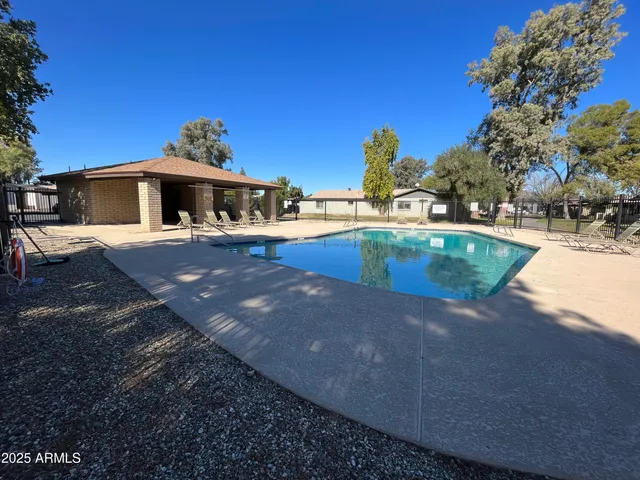 a view of a house with pool yard and outdoor seating