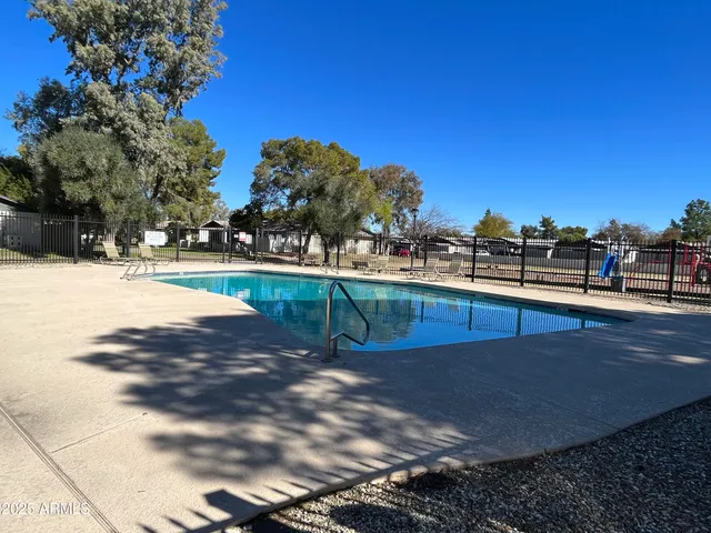 a view of a swimming pool with an outdoor seating