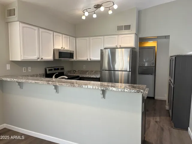 a view of a refrigerator a sink and dishwasher