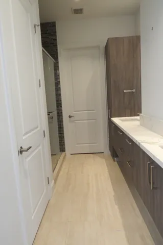 a bathroom with a tub sink vanity and shower