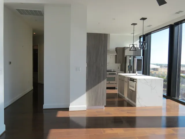 a view of kitchen with furniture and refrigerator
