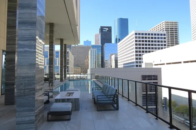 a balcony with chairs and wooden floor