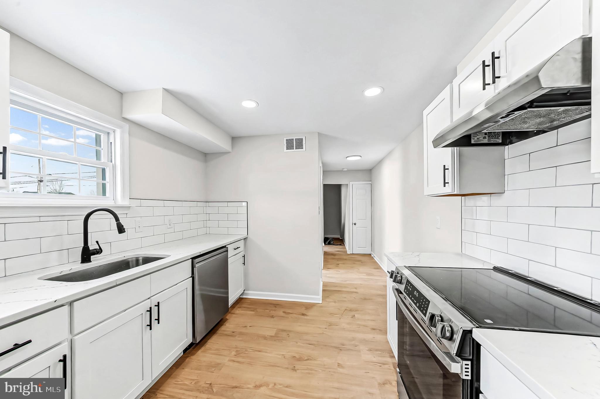 232 South 5th Street Oxford, PA 19363 - Photo 12 of 31 a kitchen with stainless steel appliances granite countertop a sink and a stove top oven