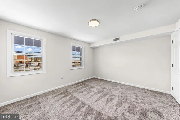 a view of a big room with closet and windows