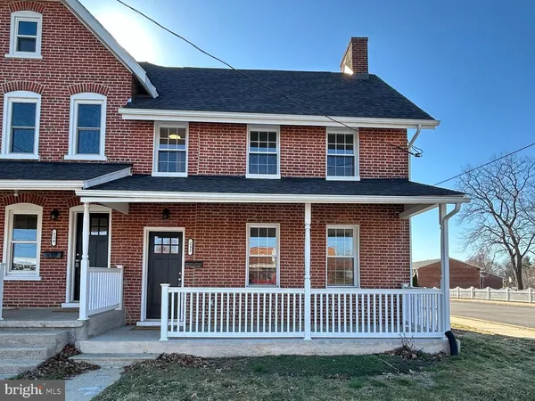 a front view of a house with yard porch and furniture