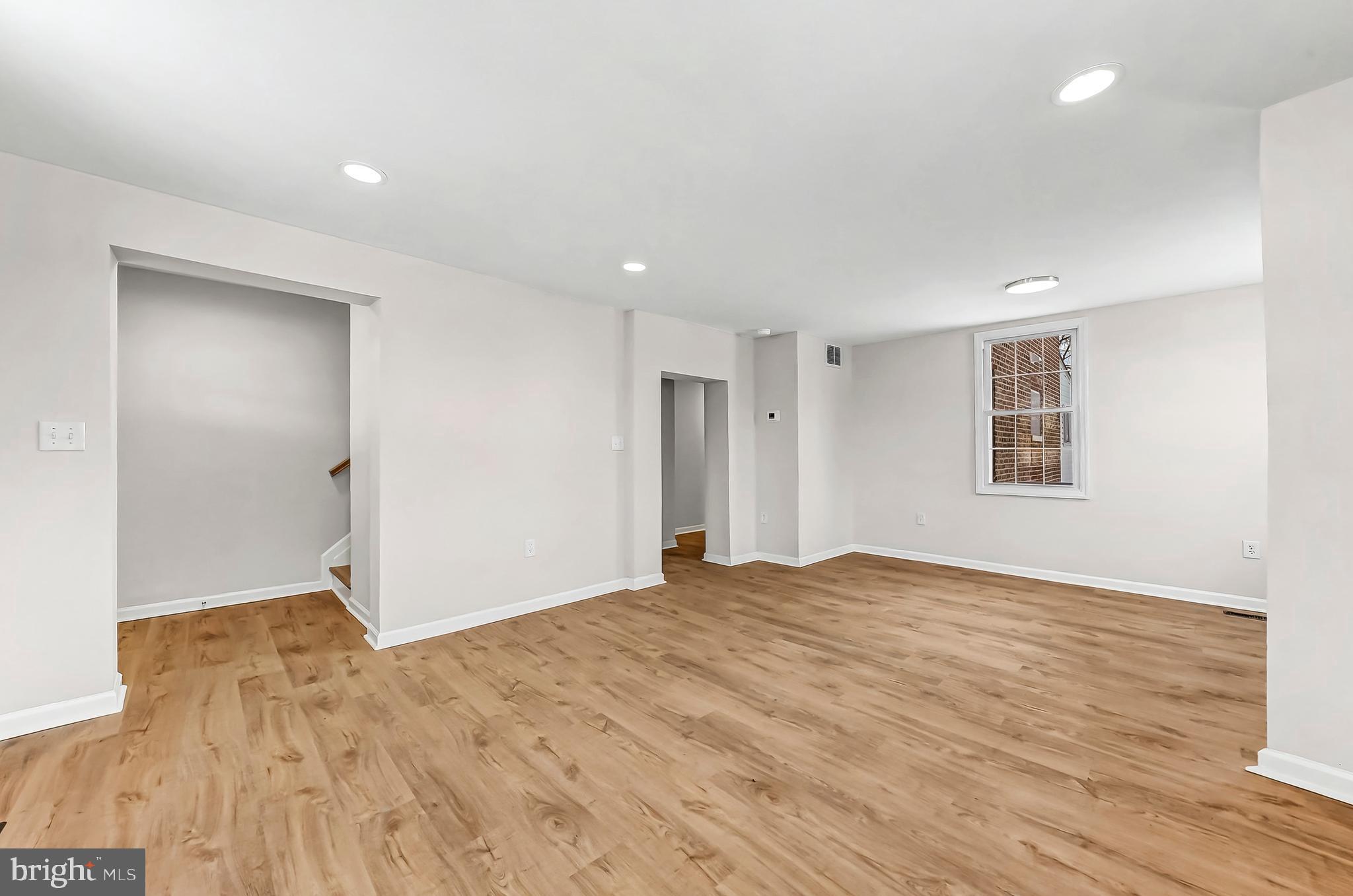 232 South 5th Street Oxford, PA 19363 - Photo 3 of 31 a view of an empty room with wooden floor and a window