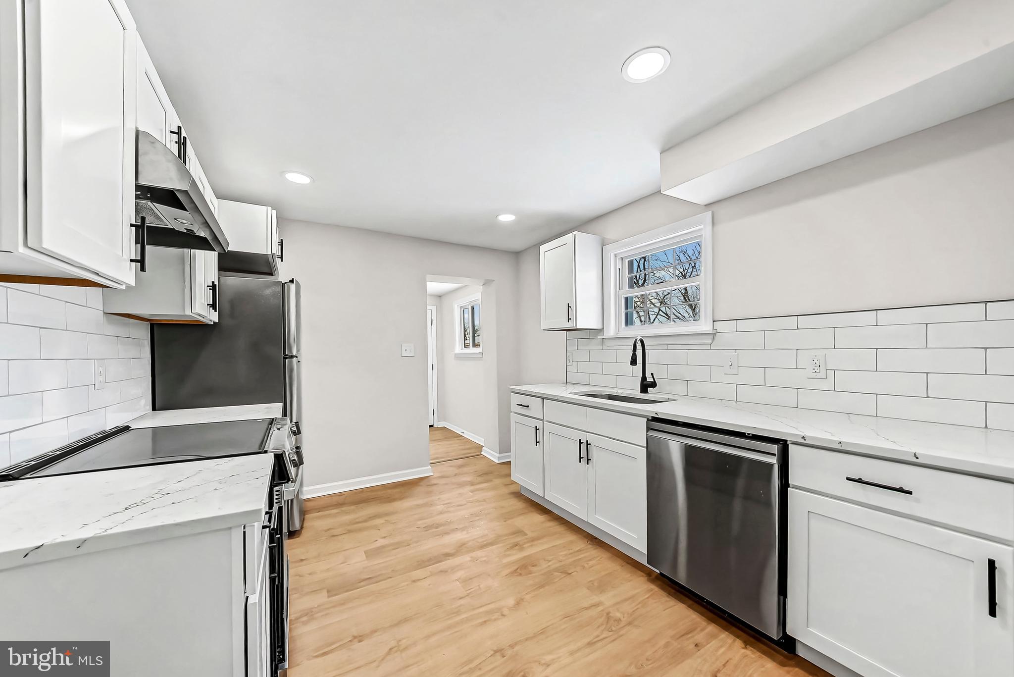 232 South 5th Street Oxford, PA 19363 - Photo 8 of 31 a kitchen with stainless steel appliances granite countertop a sink and dishwasher a stove top oven with wooden floor