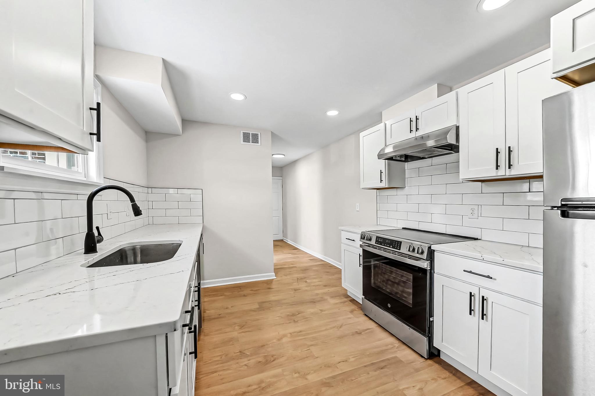 232 South 5th Street Oxford, PA 19363 - Photo 10 of 31 a kitchen with stainless steel appliances a stove sink and cabinets