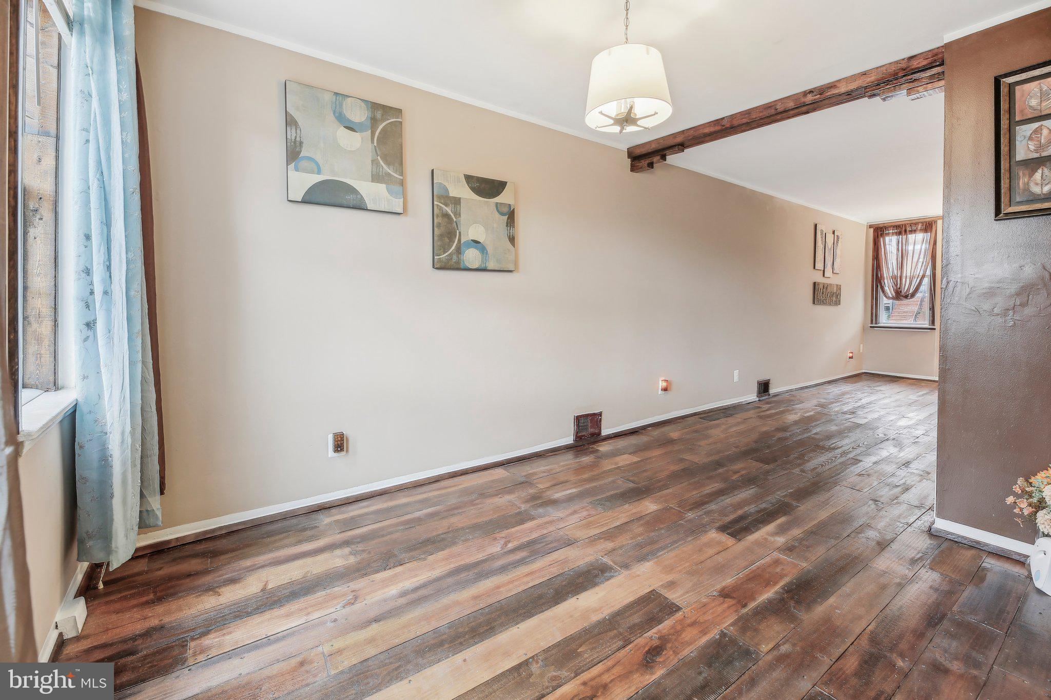 904 North Rosedale Street Baltimore, MD 21216 - Photo 11 of 38 a view of a livingroom with wooden floor and a ceiling fan