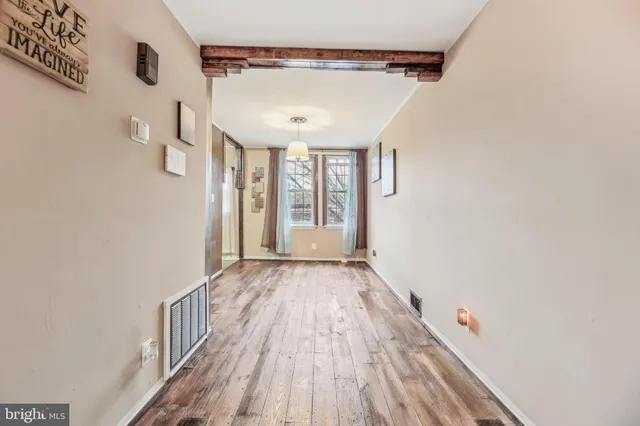 a view of a room with wooden floor and windows