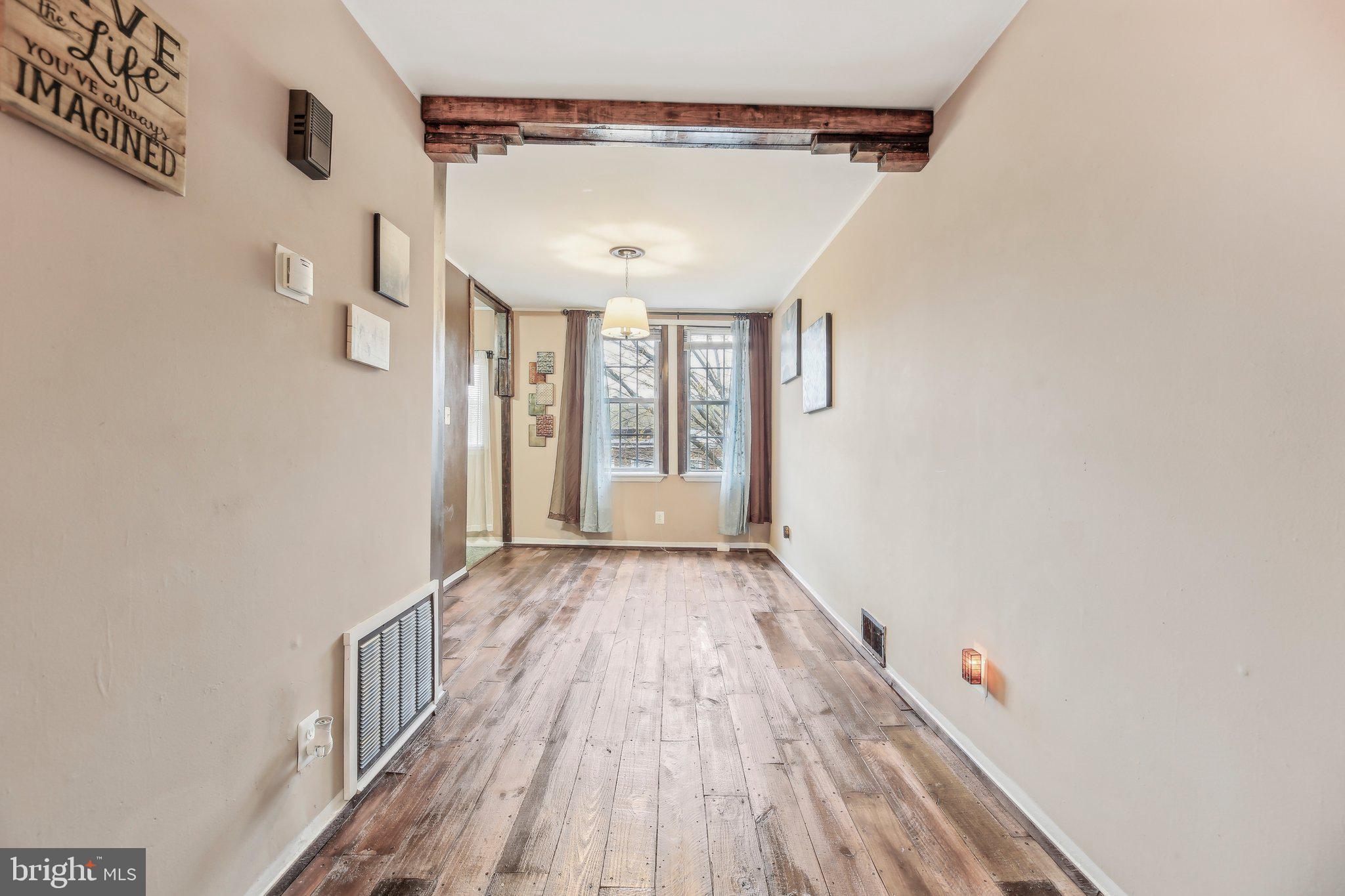 904 North Rosedale Street Baltimore, MD 21216 - Photo 13 of 38 a view of a room with wooden floor and windows