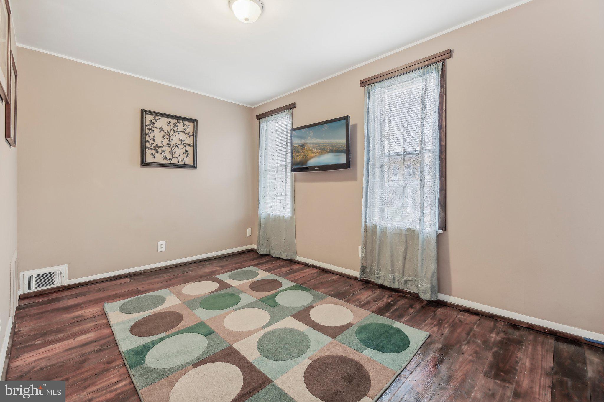 904 North Rosedale Street Baltimore, MD 21216 - Photo 18 of 38 a view of an empty room with wooden floor