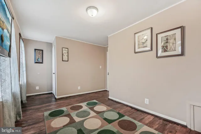 a view of an empty room with a painting on the wall