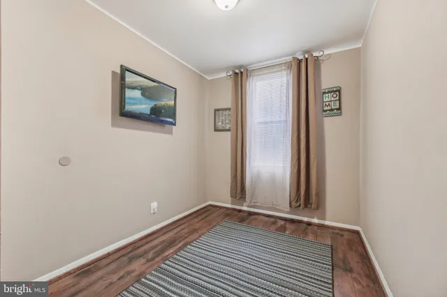 a view of a room with wooden floor