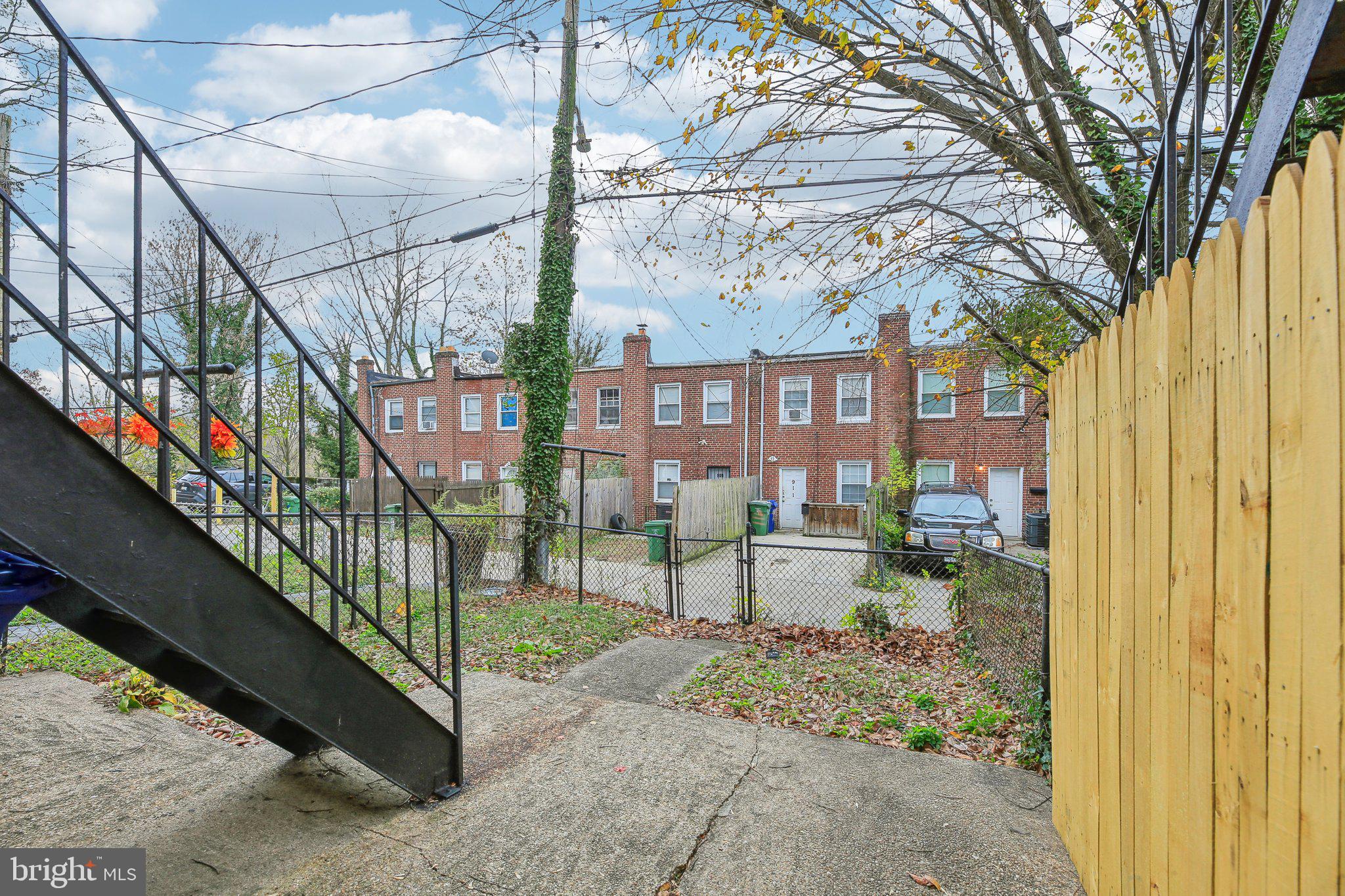 904 North Rosedale Street Baltimore, MD 21216 - Photo 34 of 38 a view of a house with a small yard and wooden fence