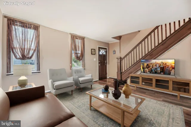 a living room with furniture gym equipment and a rug