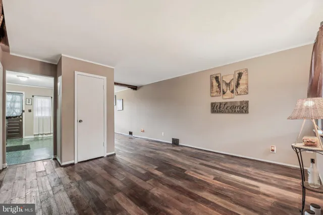 a view of a room with wooden floor