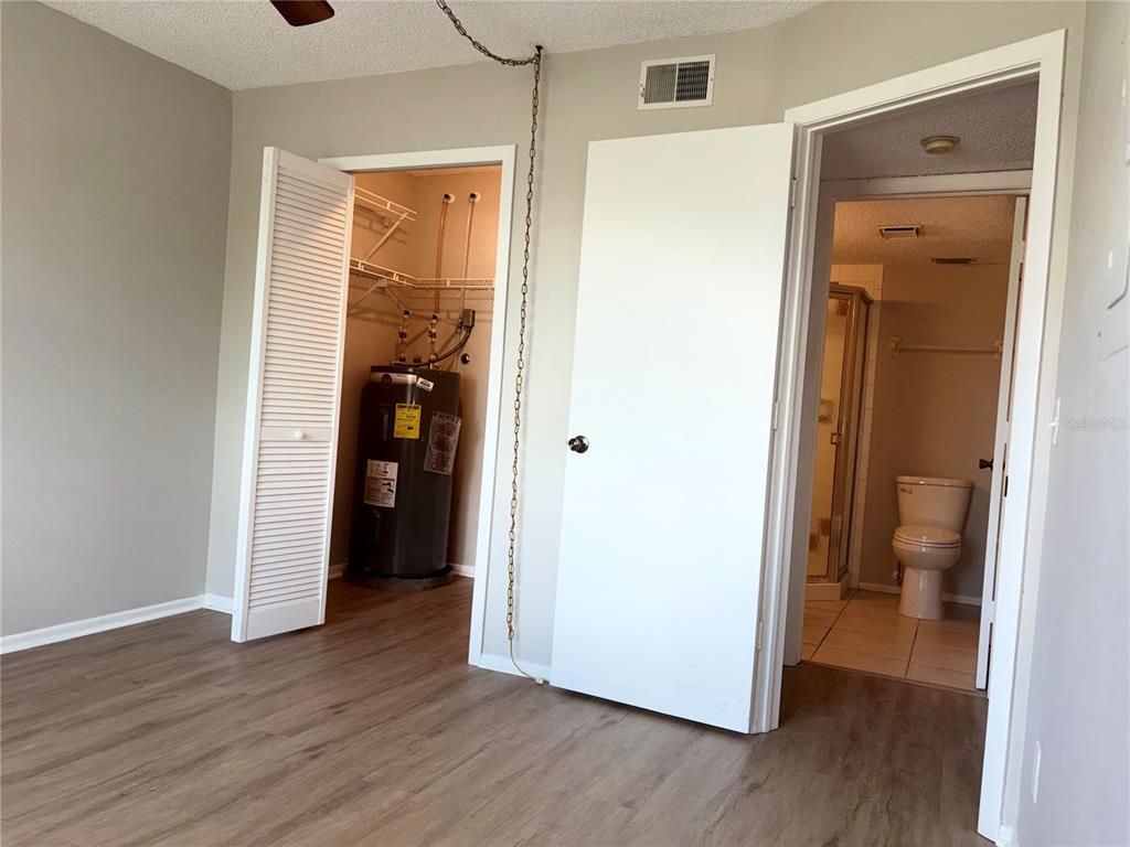 26485 Rampart Boulevard, Unit D1 Punta Gorda, FL 33983 - Photo 15 of 29 a view of a hallway with wooden floor and closet area