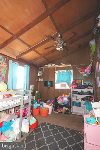 a room with furniture a flat screen tv and a window