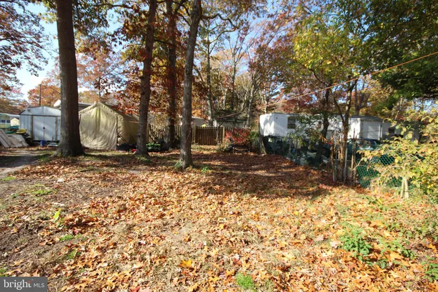 a view of a house with cars parked in front of house