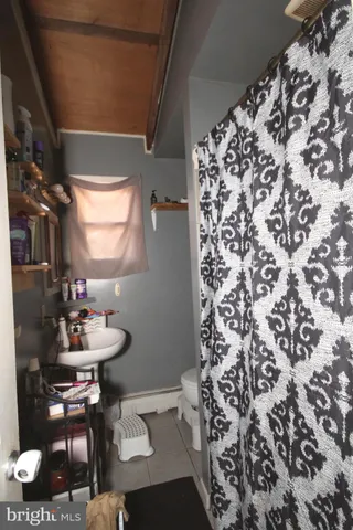 a bathroom with a sink toilet and a mirror